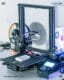 Close-up of a 3D printer in action, producing components for an interactive data sculpture by Steve Zafeiriou, showcasing the integration of technology and art through 3D printing for tactile data visualization projects.