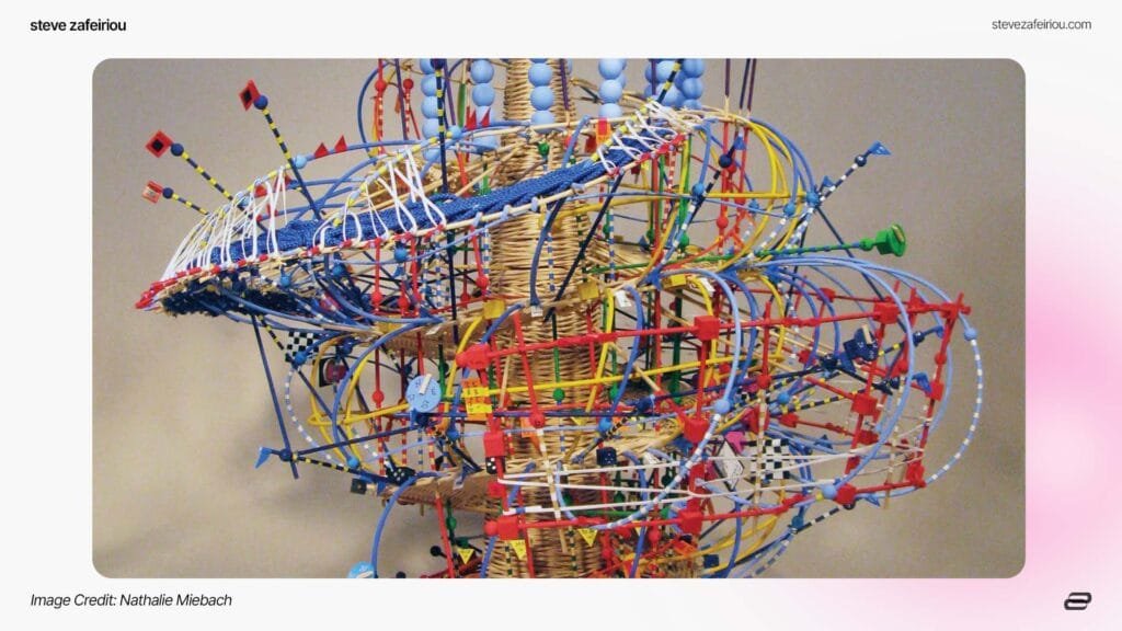 Close-up view of Nathalie Miebach's intricate woven sculpture, showcasing her signature method of transforming meteorological data into three-dimensional artistic interpretations. The colorful structure integrates weather patterns and scientific observations, blending art and science for engaging climate storytelling. Image Credit: Nathalie Miebach.