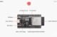 ESP32 Pinout Guide: ESP32 DevKit V4 board featuring ESP32-WROOM-32 module with labeled components such as EN button, boot button, micro USB port, I/O connectors, USB-to-UART bridge, and power indicator LED.