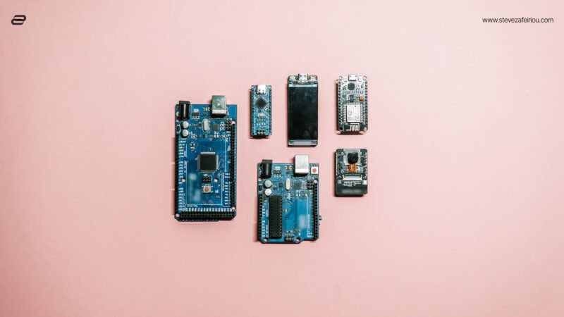 Arduino and ESP32 microcontroller development boards on a pink background, illustrating key components of embedded systems and electronics prototyping.