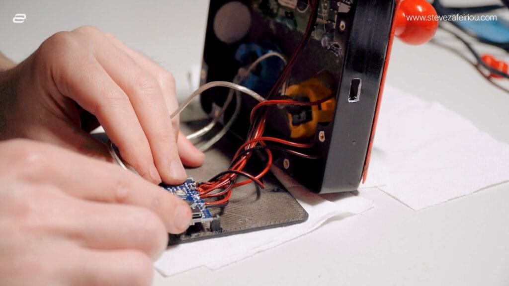 Wiring an Arduino Nano to a custom-built arcade console, showcasing circuit connections and DIY electronics for retro gaming projects.