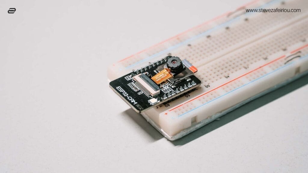 Close-up perspective view of an ESP32-CAM module neatly placed on a breadboard, suitable for IoT and electronics prototyping.