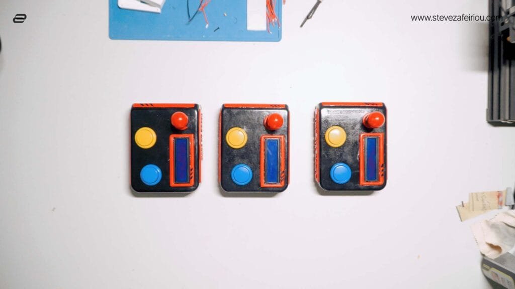 anoramic view of three custom-built arcade consoles, showcasing electronic engineering, retro gaming design, and DIY craftsmanship.