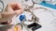 Hands-on soldering of a mini arcade button for a custom gaming console, demonstrating DIY electronics and arcade component assembly.