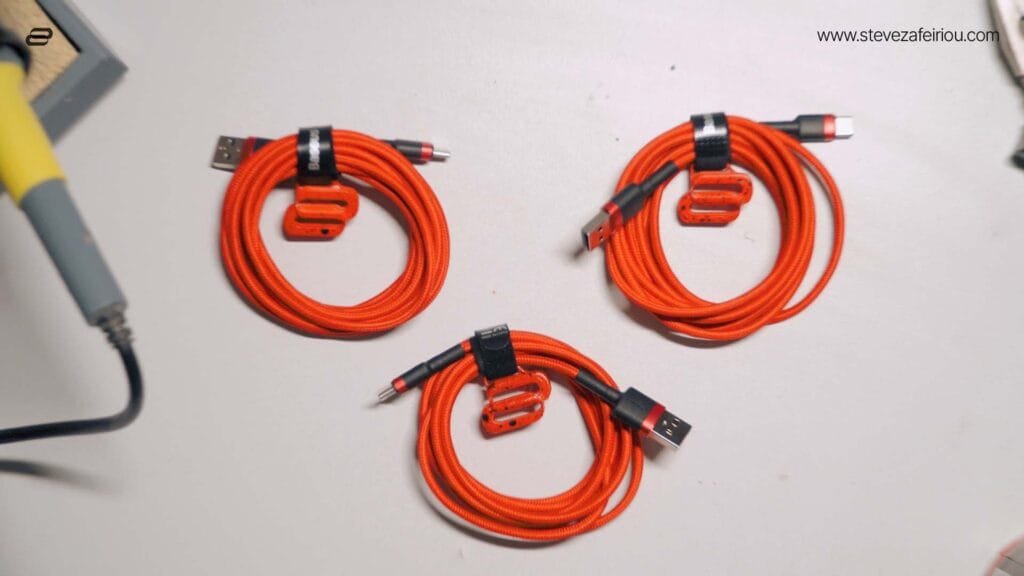 USB-C cables alongside a 3D-printed Saphire Labs logo, featuring high-quality custom branding and electronic accessories.